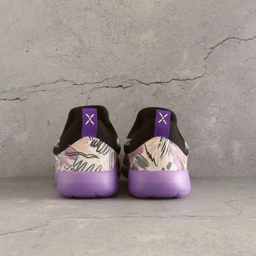 Black and purple 90s style kids slip-on sneakers with bold patterns and supportive cushioning.