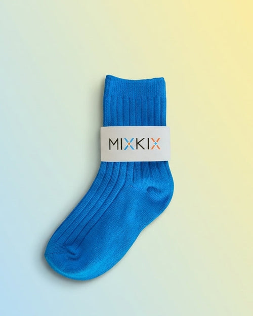 A single bright blue sock with a white band around the calf displaying the brand name 'MIXKIX' designed fir kids with cotton. 