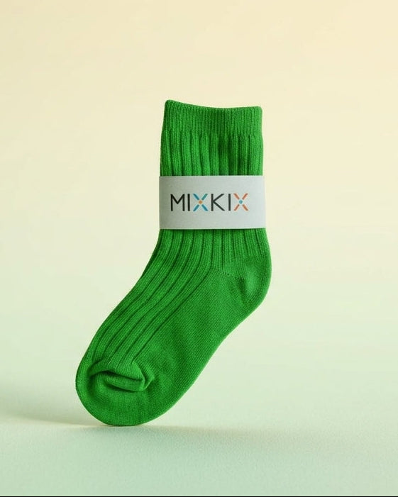 A single bright green crew sock with a white band around the calf displaying the brand name 'MIXKIX' . Crew sock in solid colours for kids.