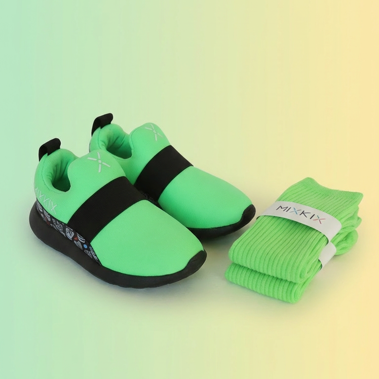 Pair of neon green shoes with black soles and matching socks on a gradient background