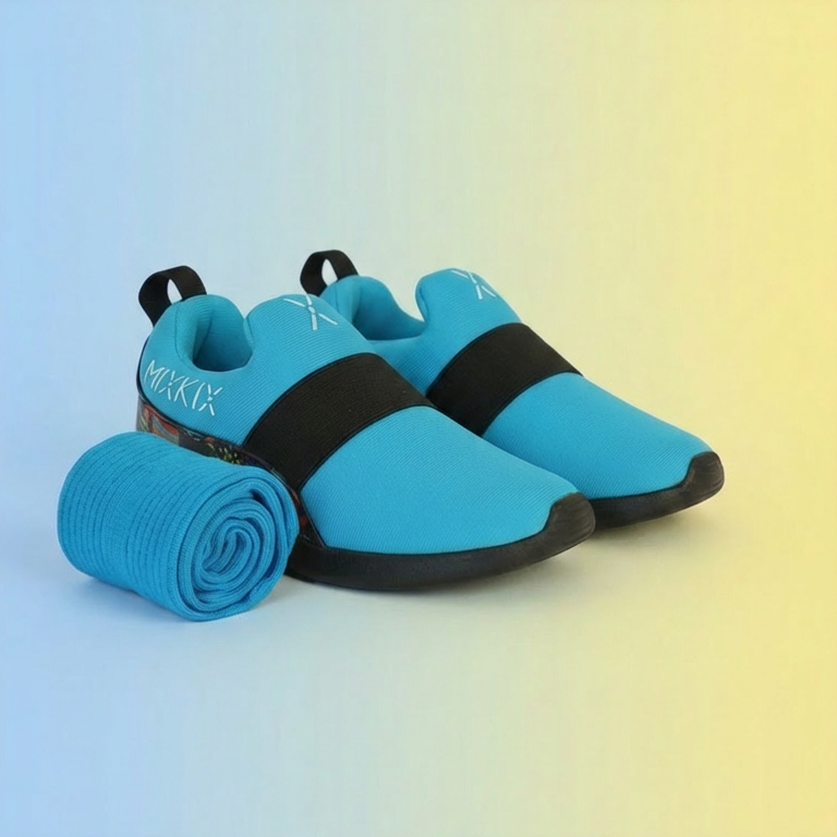 Blue slip-on shoes with black straps and matching children cotton socks on a gradient background