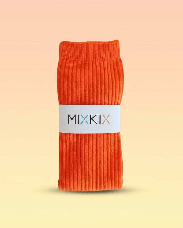 An orange ribbed knit sock bundle wrapped in a white paper band with the brand name 'MIXKIX' 
